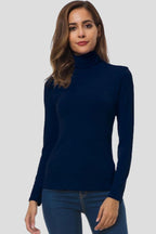 Woman wearing a navy turtleneck long sleeve plain sweater - studio photo