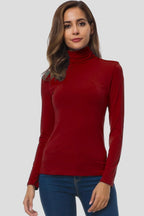 Woman wearing a red turtleneck long sleeve plain sweater - studio photo