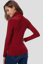 Woman wearing a red turtleneck long sleeve plain sweater - studio photo
