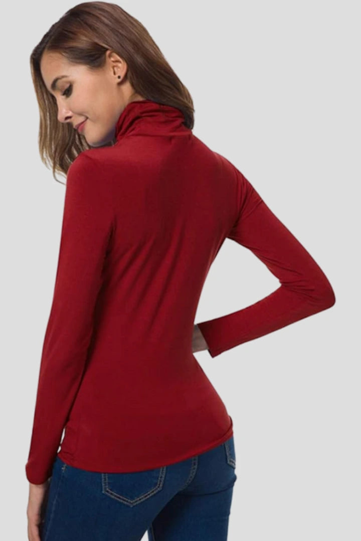 Woman wearing a red turtleneck long sleeve plain sweater - studio photo