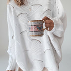 Close-up of white oversized open knit sweater texture and sleeve