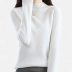 Woman wearing a white wool half-neck sweater in a studio setting