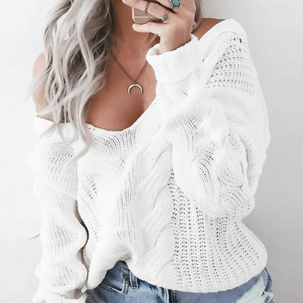 Close-up of white oversized openwork sweater with cable texture