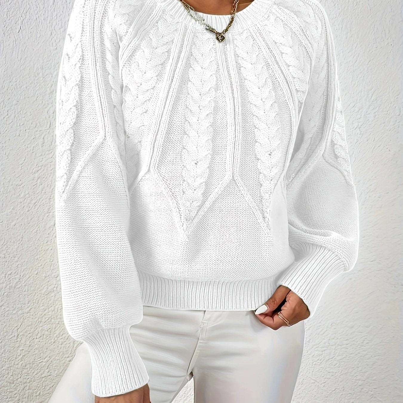 Woman wearing a white voluminous sleeve sweater with cable knit texture