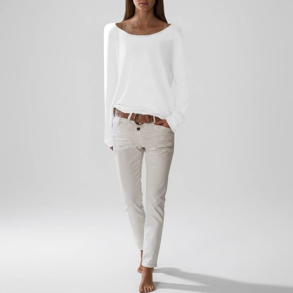 Woman wearing a white lightweight boat neck sweater, full length view