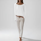Woman wearing a white lightweight boat neck sweater, full length view