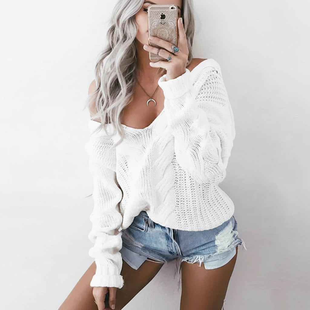 Woman wearing white oversized openwork sweater with cable texture, studio photo