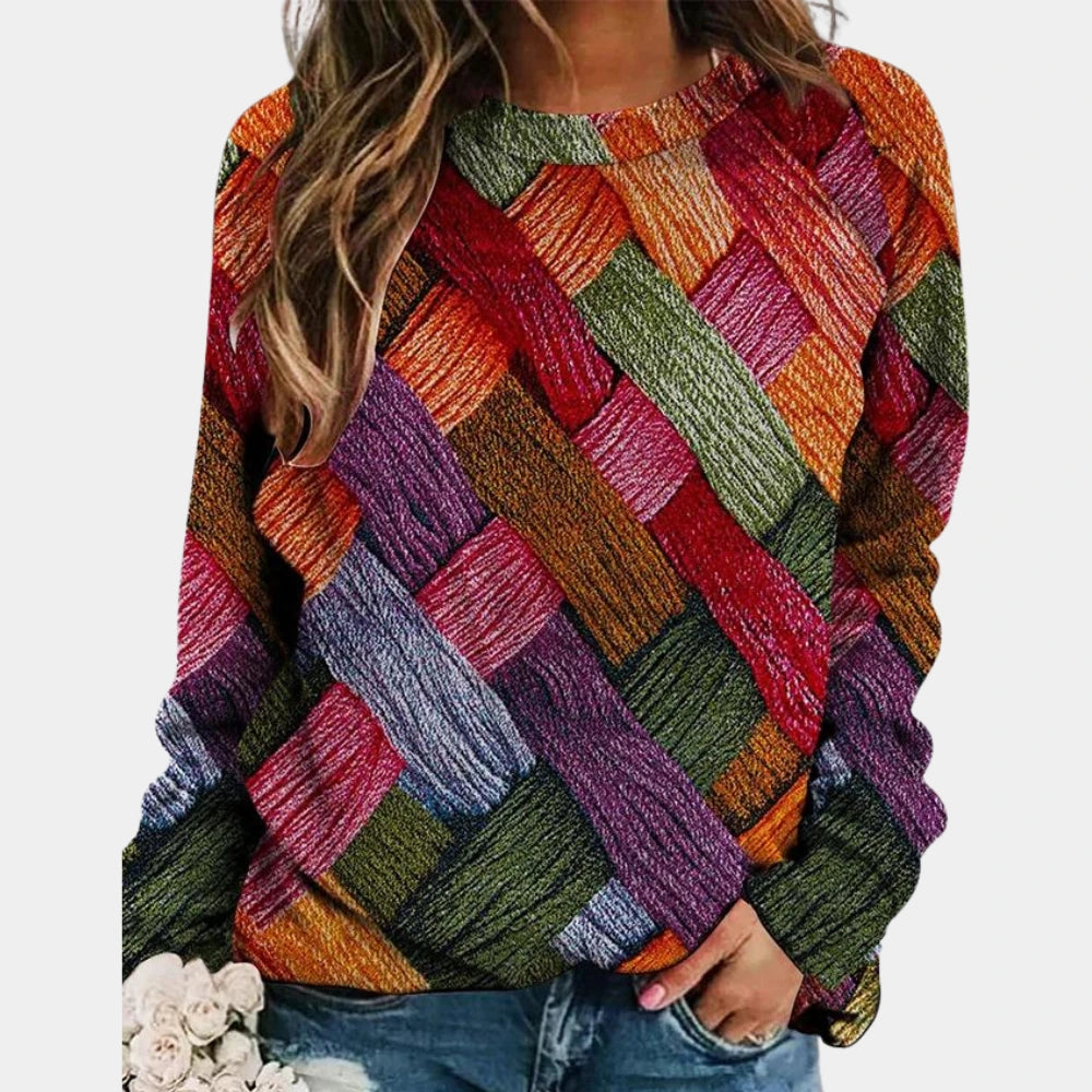 Woman wearing a wine red colorblock diamond knit sweater with long sleeves