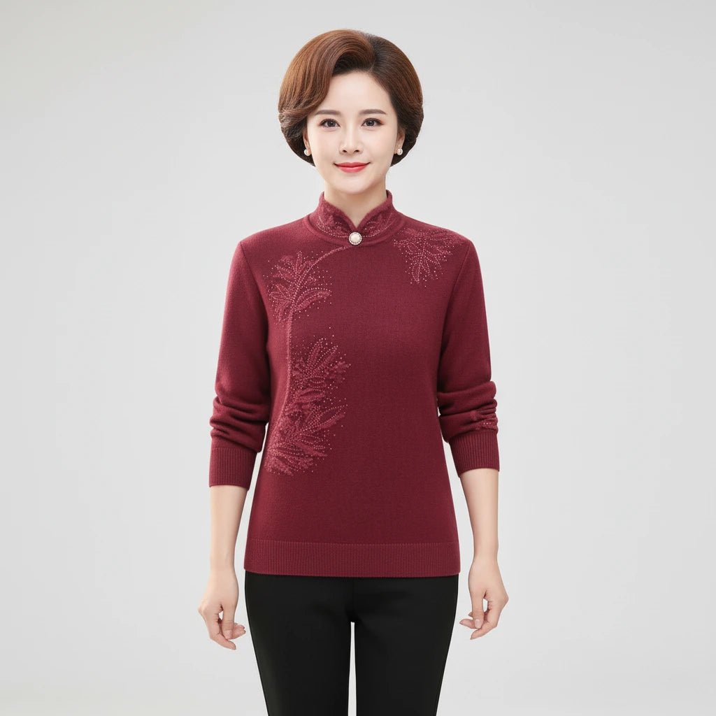 Woman wearing wine red high-collar sweater with printed button detail, studio photo