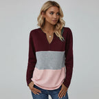 Woman wearing wine red panelled V-neck sweater, studio photo