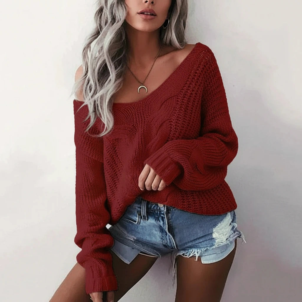 Woman wearing wine red oversized openwork sweater with cable texture, studio photo
