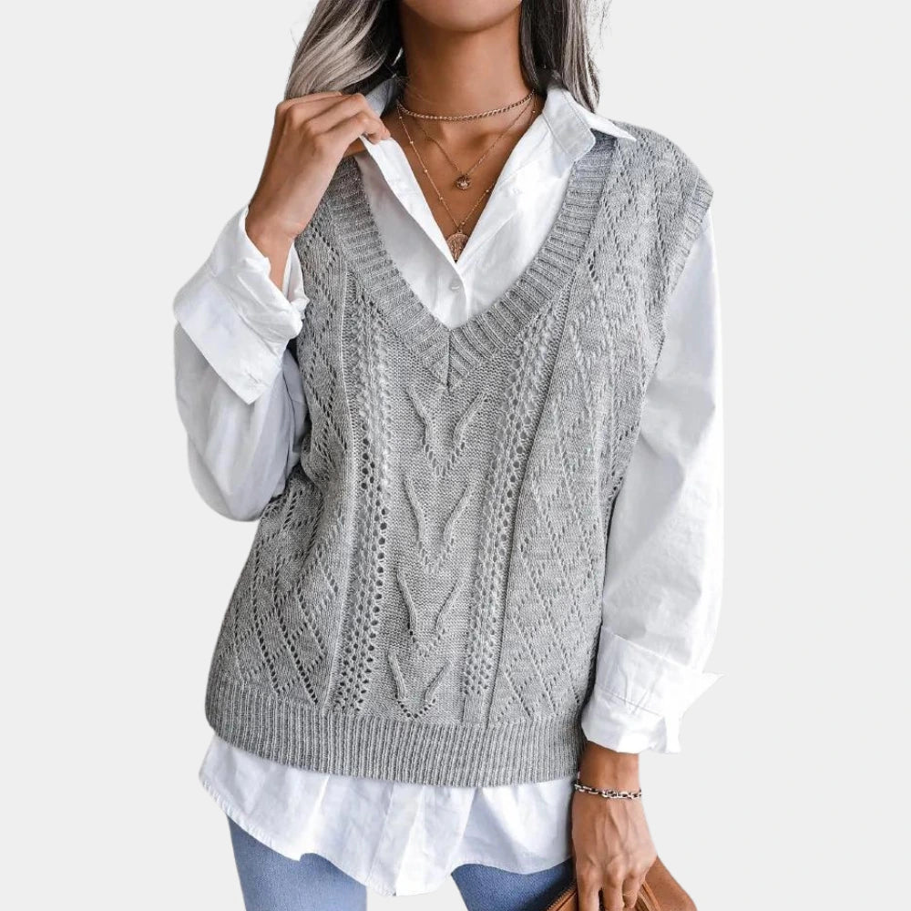 Close-up of grey openwork sweater vest texture and V neck detail