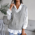 Woman wearing a grey openwork sweater vest with ribbed V neck over a white shirt