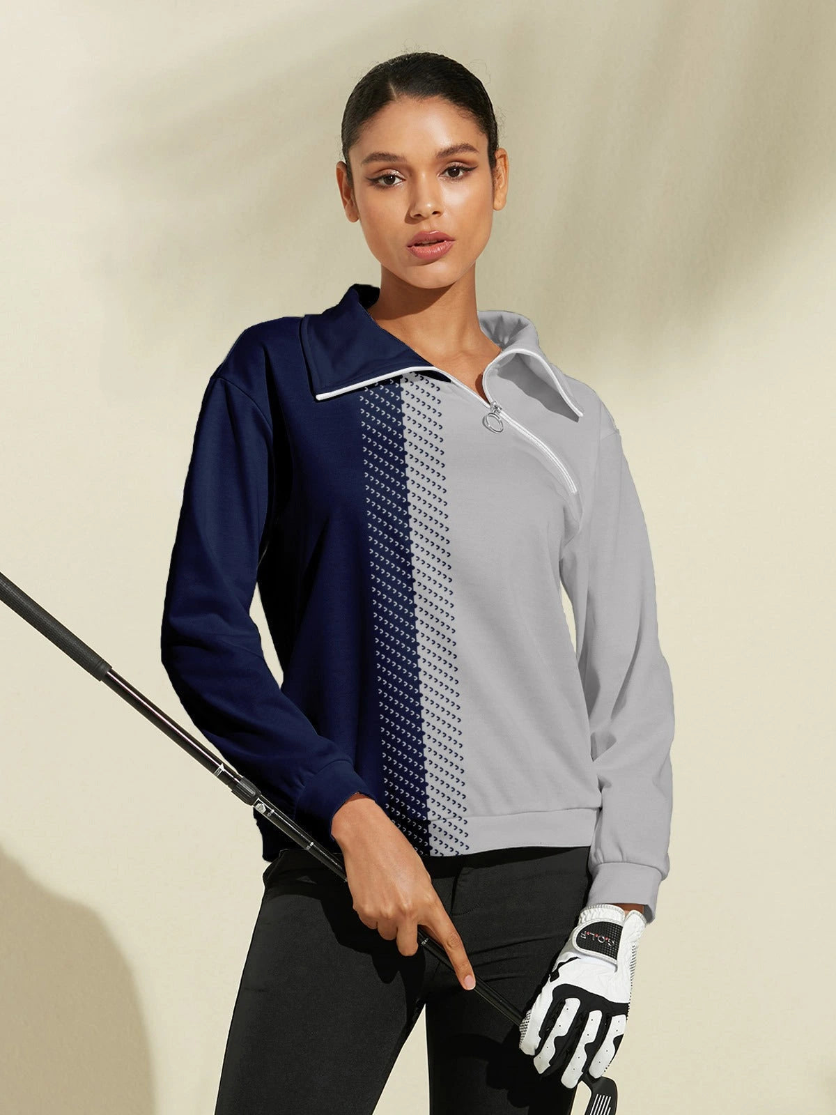 Model wearing navy and grey quarter-zip golf sweatshirt holding golf club