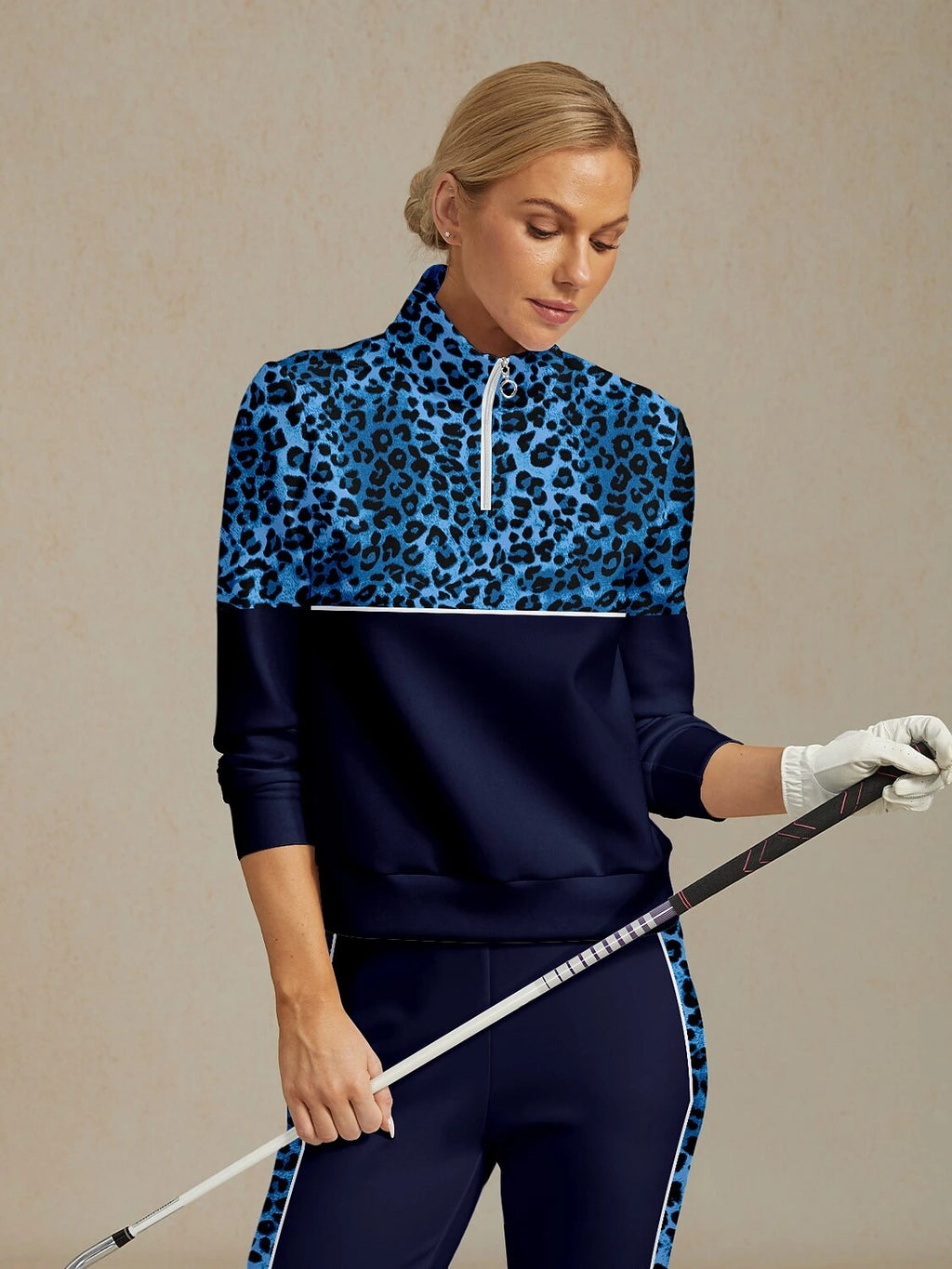 Navy blue leopard print golf sweatshirt, model holding golf club