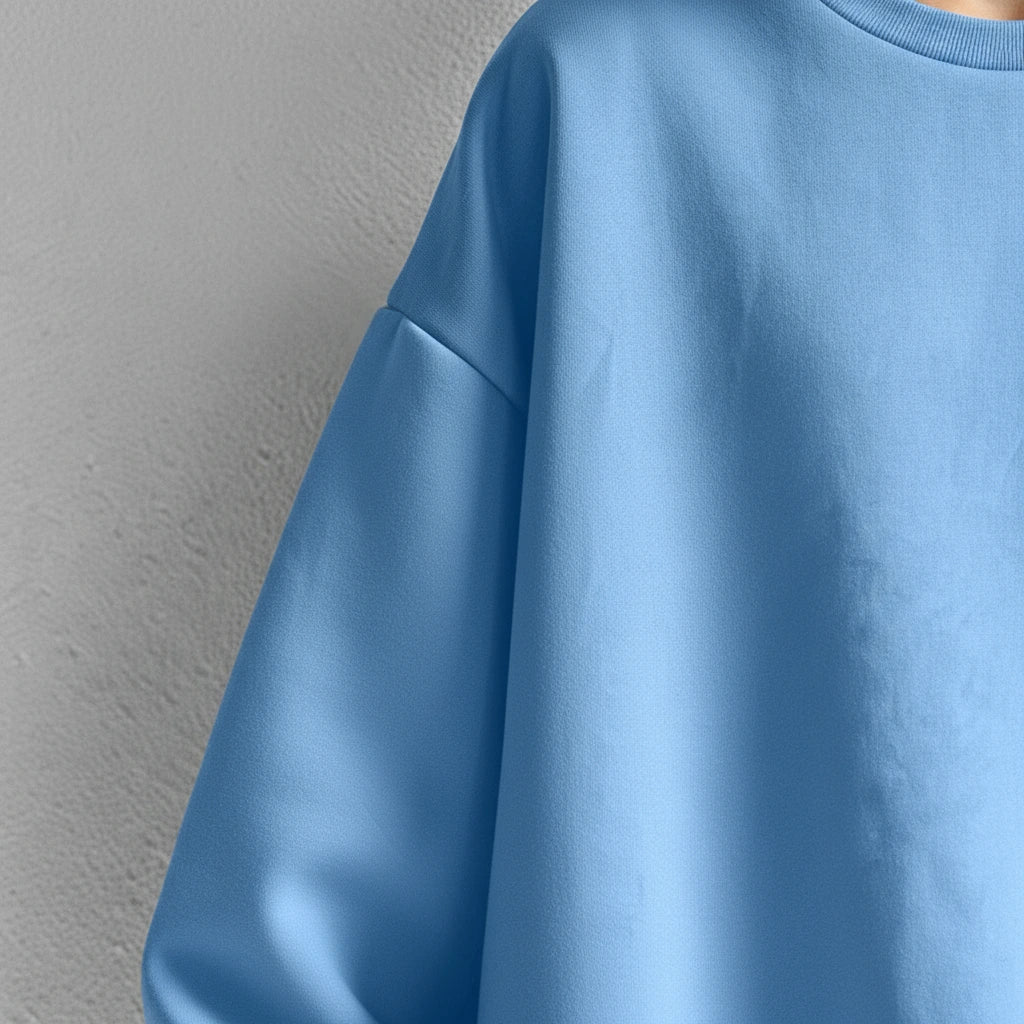 Sky blue oversized sweatshirt, close-up of dropped shoulder and sleeve