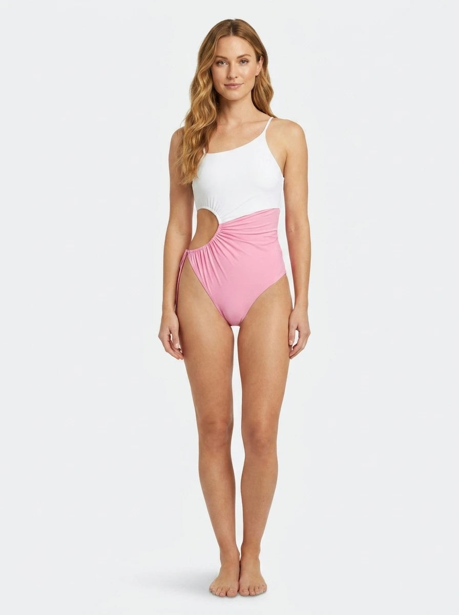 Woman wearing a white and pink color-block one-piece swimsuit, studio photography, front view