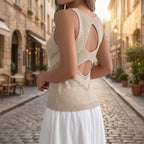 Driftly women's khaki sleeveless V-neck tank top, styled with a white midi skirt on a European street at golden hour.
