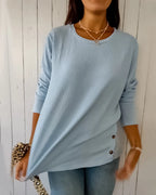 Blue ribbed knit top close-up detail with side button trim