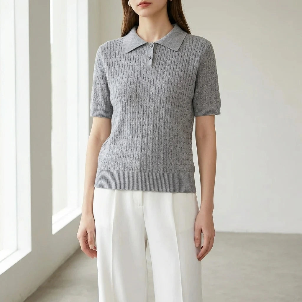 Driftly women's gray cotton polo t-shirt, styled with white wide-leg trousers in a minimalist studio setting.