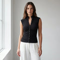 Driftly women's black ribbed ruched button front top, styled with white wide-leg trousers in a minimalist studio setting.