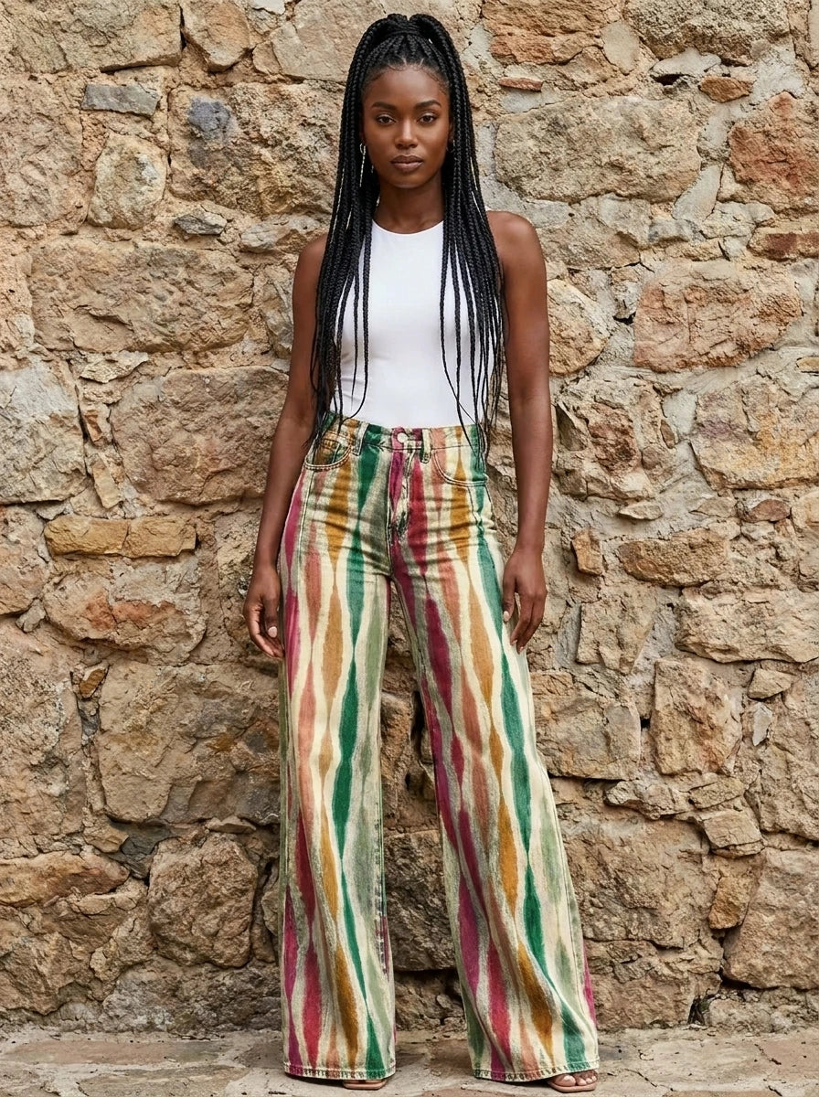 Woman wearing multicolor striped bohemian wide-leg trousers against a stone wall