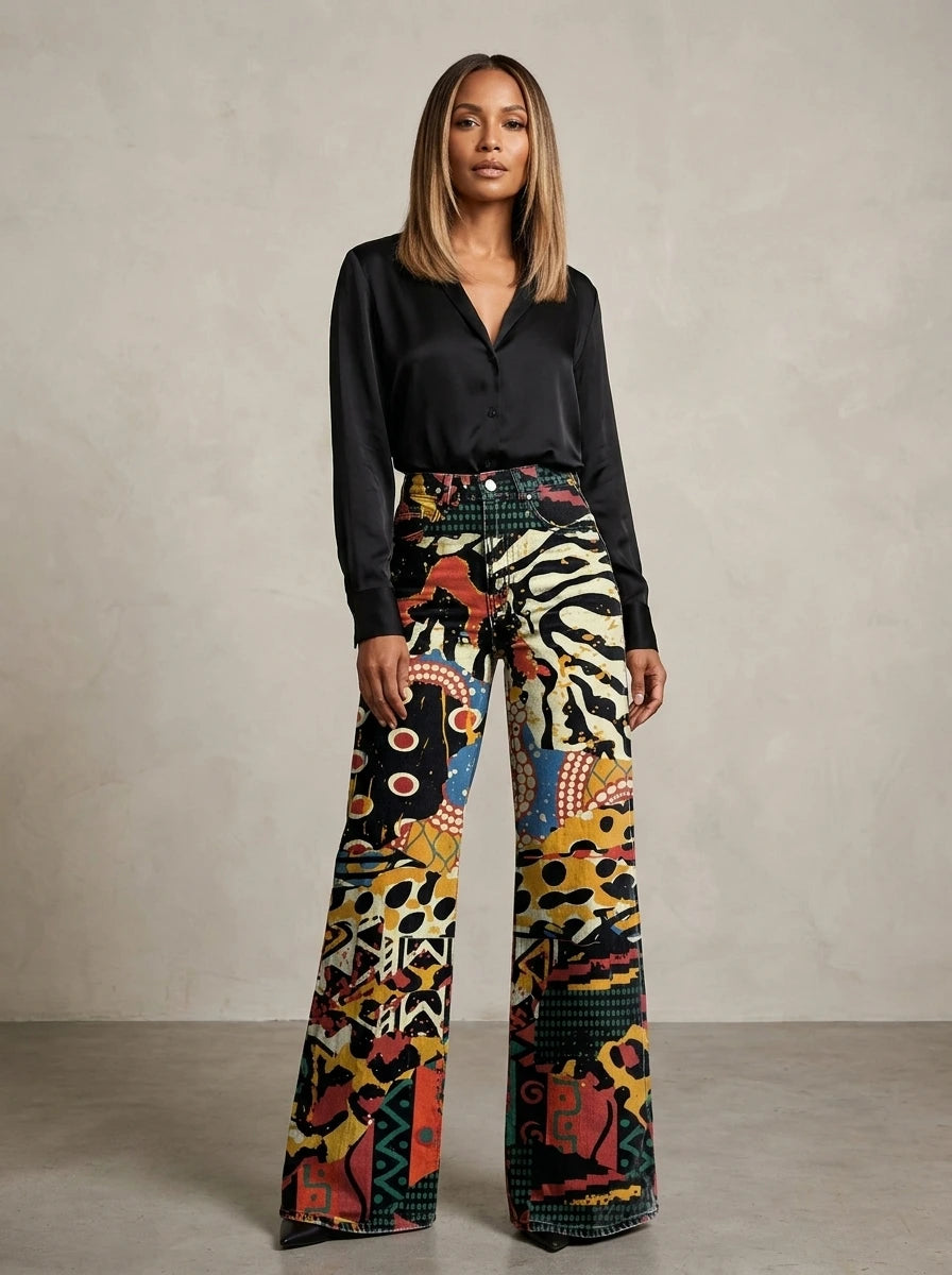 Woman wearing black chic wide-leg trousers with an animal-print pattern, studio setting