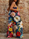 Woman wearing multicolored floral print wide leg trousers against a brick wall