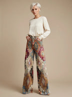 Woman wearing brown vintage chic high-waisted patterned trousers, studio setting