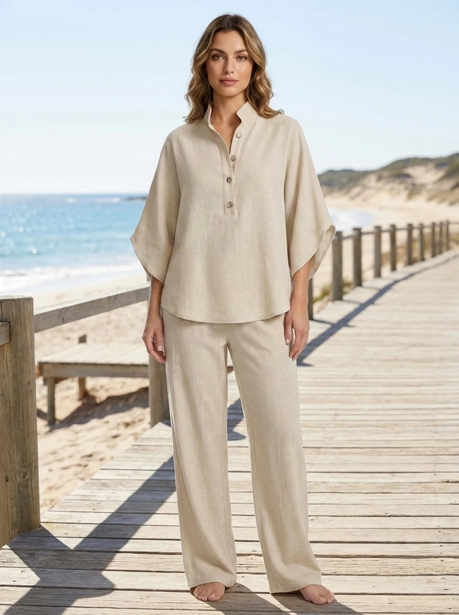 Woman wearing a sand beige linen-style two-piece set on the beach, relaxed casual summer outfit