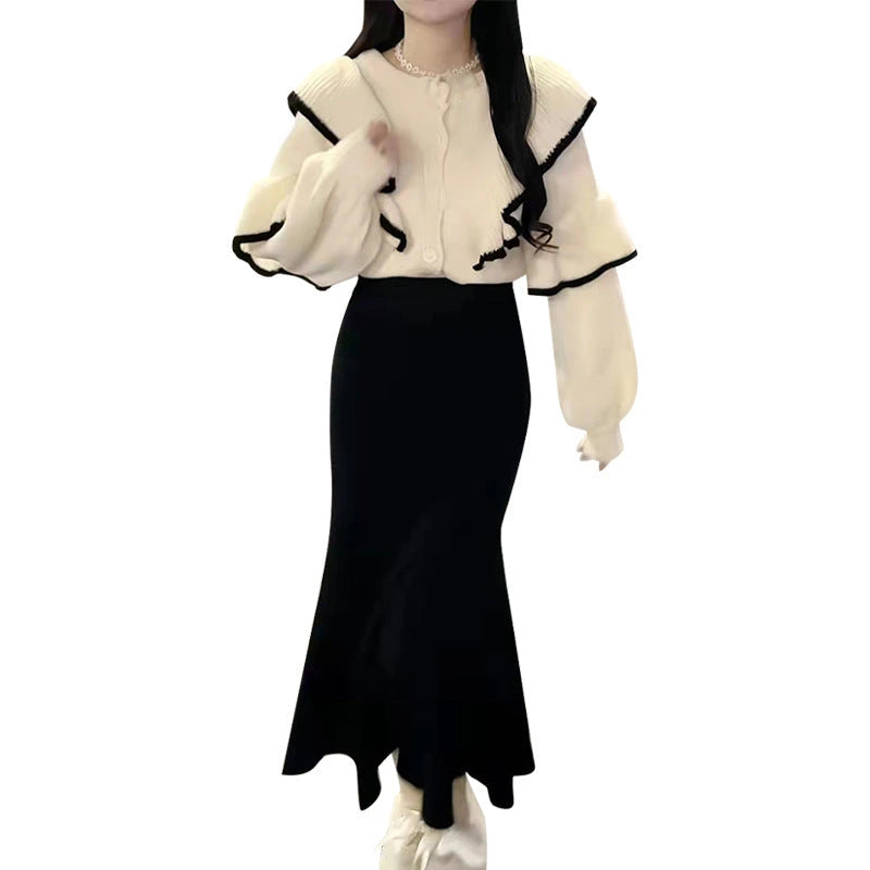 Close-up detail of ruffle trim and black contrast piping on blouse