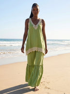 Woman wearing a green eyelash lace cami top and wide-leg pants two-piece set on a sunny beach