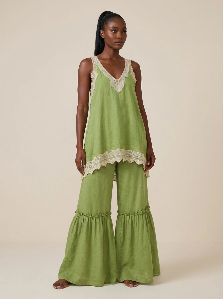 Woman wearing a green eyelash lace cami top and wide-leg pants two-piece set in a studio setting