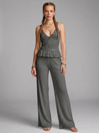 Woman wearing a grey ribbed cami crop top and matching wide-leg pants two-piece set in a studio setting