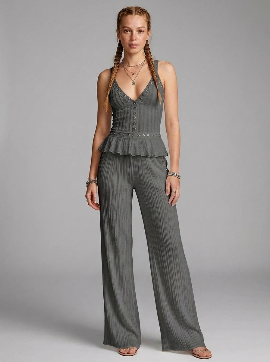 Woman wearing a grey ribbed cami crop top and matching wide-leg pants two-piece set in a studio setting