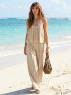 Woman wearing a khaki ruched cami and wide-leg drape two-piece set on a tropical beach