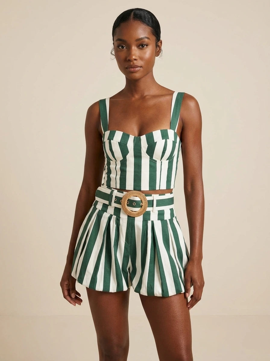 Woman wearing a green striped smocked tank top and bubble shorts two-piece set in a studio setting