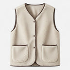 Beige plush sherpa vest flat lay studio shot