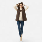 Woman wearing a dark coffee brown plush sherpa vest, lifestyle shot
