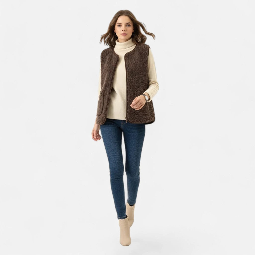 Woman wearing a dark coffee brown plush sherpa vest over a cream top