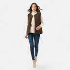 Woman wearing a dark coffee brown plush sherpa vest over a cream top