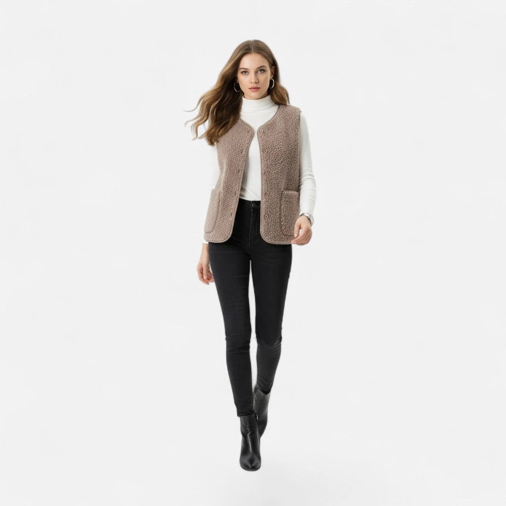 Woman wearing a light coffee taupe plush sherpa vest, second lifestyle shot