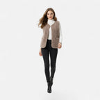 Woman wearing a light coffee taupe plush sherpa vest, second lifestyle shot