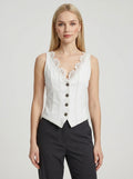 Woman wearing a white sleeveless vintage lace collar vest in a studio setting