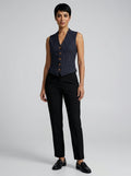 Woman wearing a navy vintage striped sleeveless vest in a studio setting
