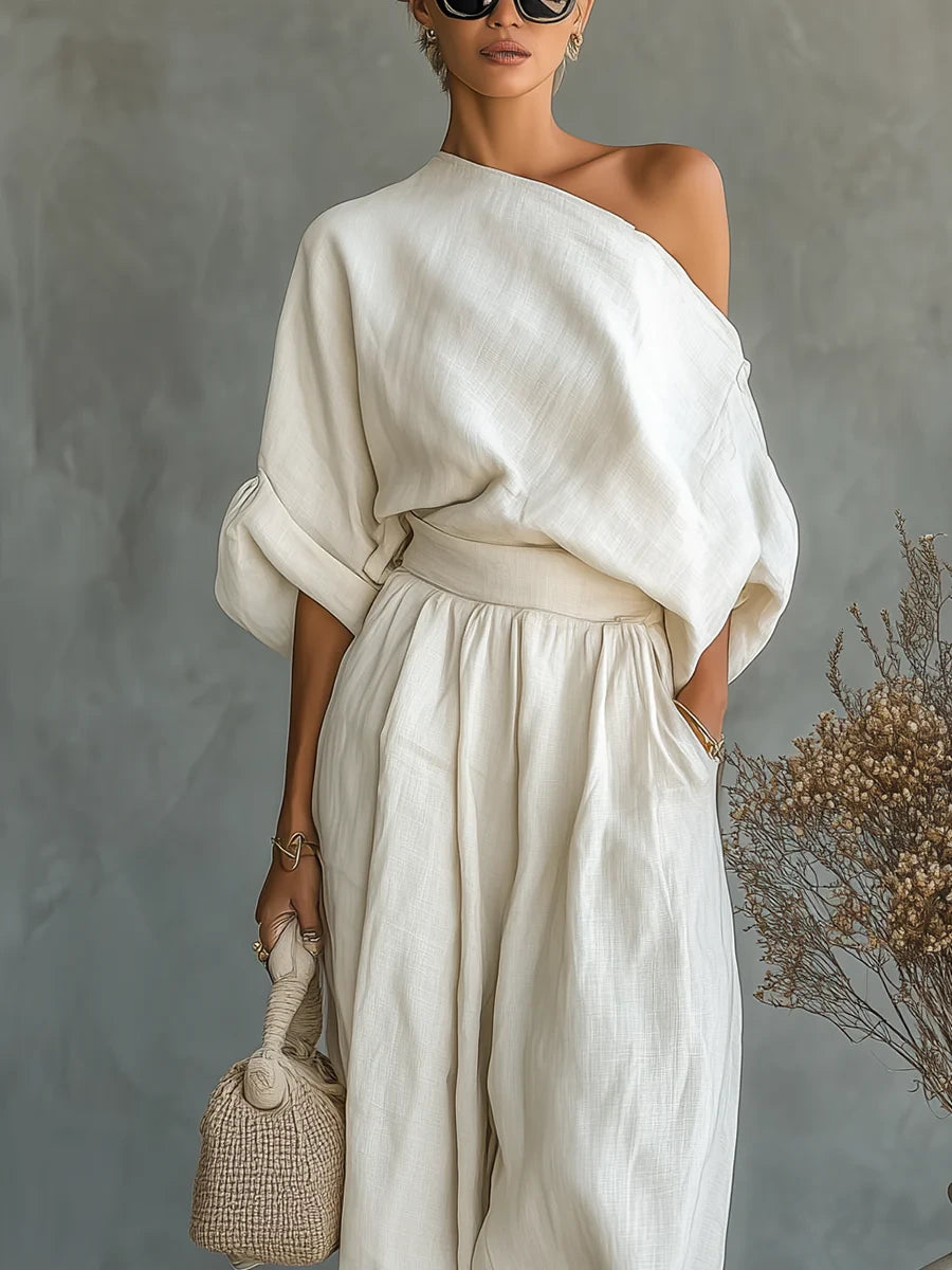 Woman wearing an off-white off-shoulder two-piece outfit, close-up front view