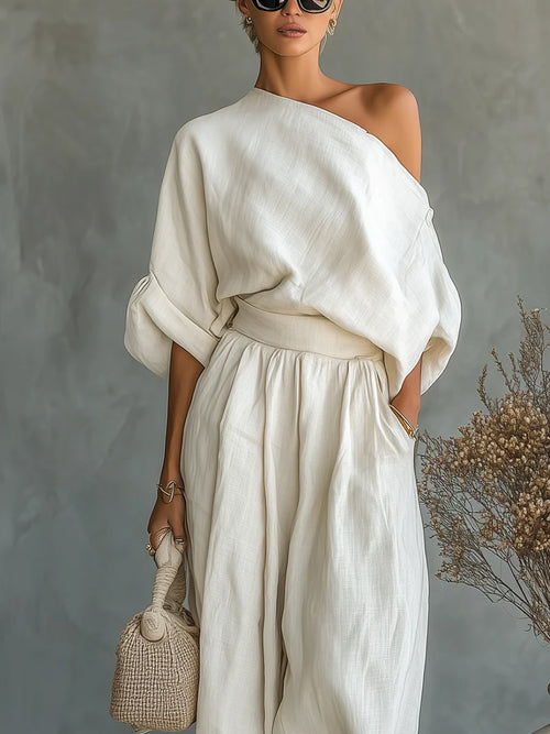 Woman wearing an off-white off-shoulder two-piece outfit, close-up front view