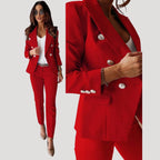 Woman wearing a red double-breasted tailored blazer and trouser set