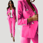 Woman wearing a dark pink double-breasted tailored blazer and trouser set