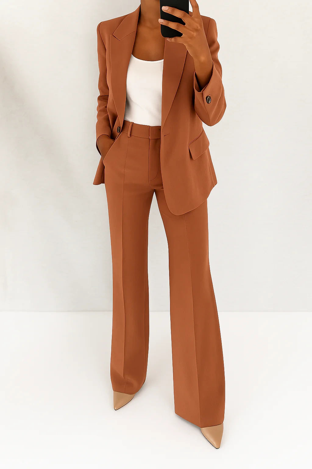 Woman wearing a brown wide-leg button-down blazer and trouser set in a studio setting